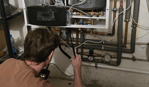 Paweł Szymaniak wykonuje przegląd pieca gazowego w Myśliborzu – pomiar analizatorem spalin i kontrola szczelności instalacji